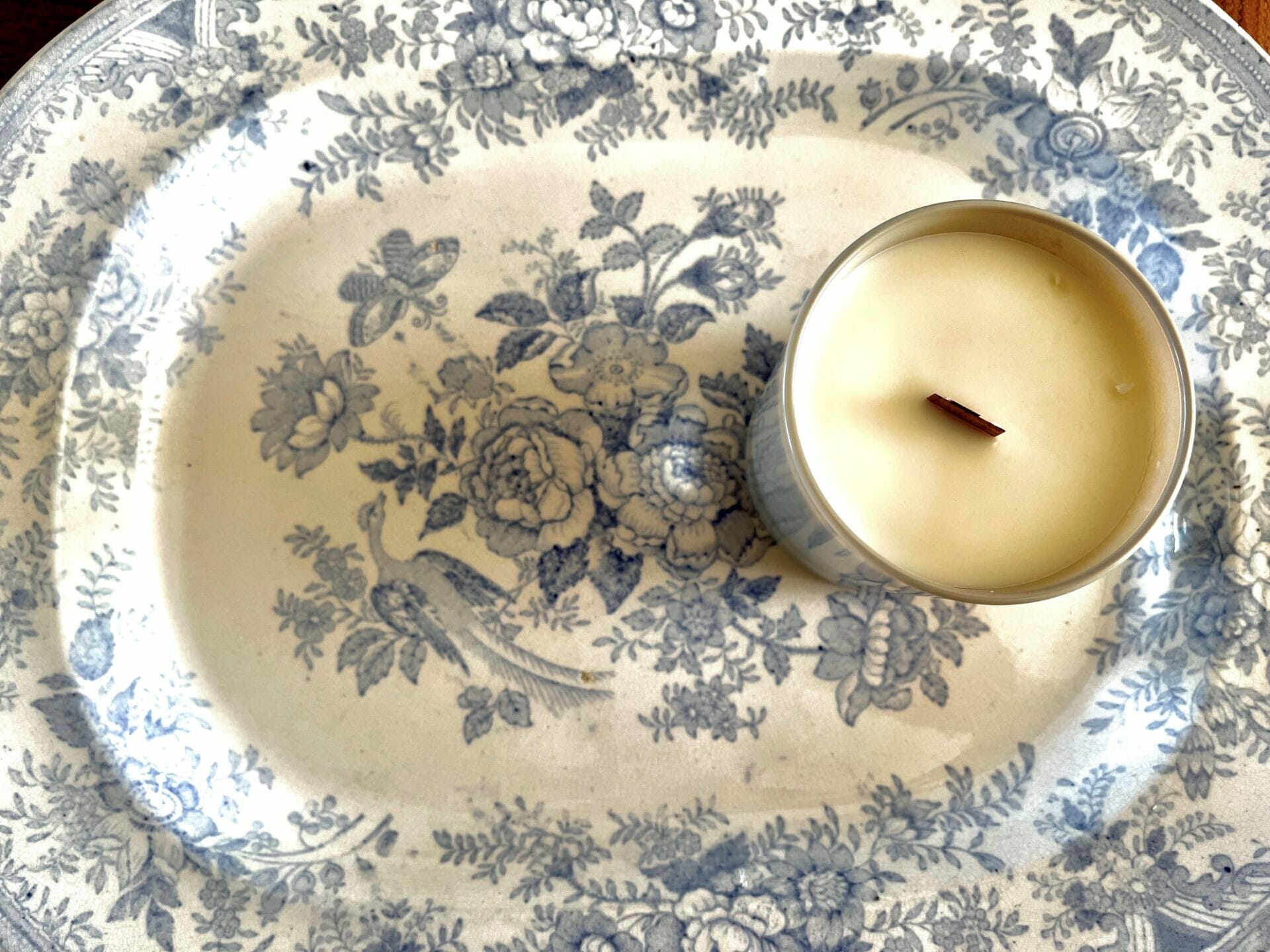Unlit candle on old blue and white plate
