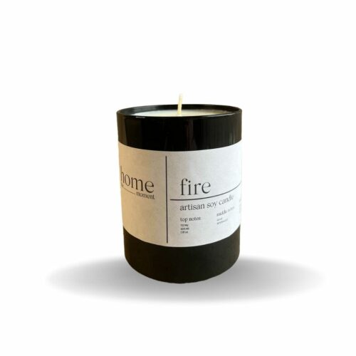 Black glass jar with white label containing a soy wax candle