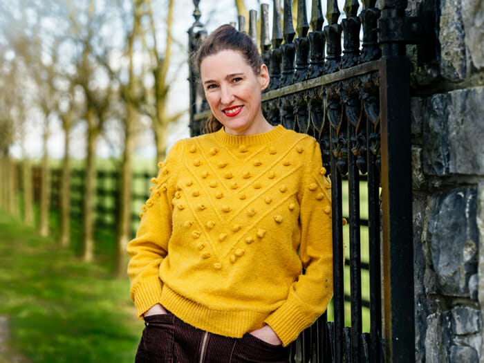 Picture of Jennifer Doyle, Irish Chandler. Wearing a yellow jumper.