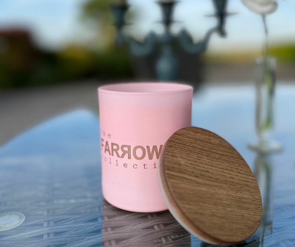 Farrow pink candle sitting on table in garden
